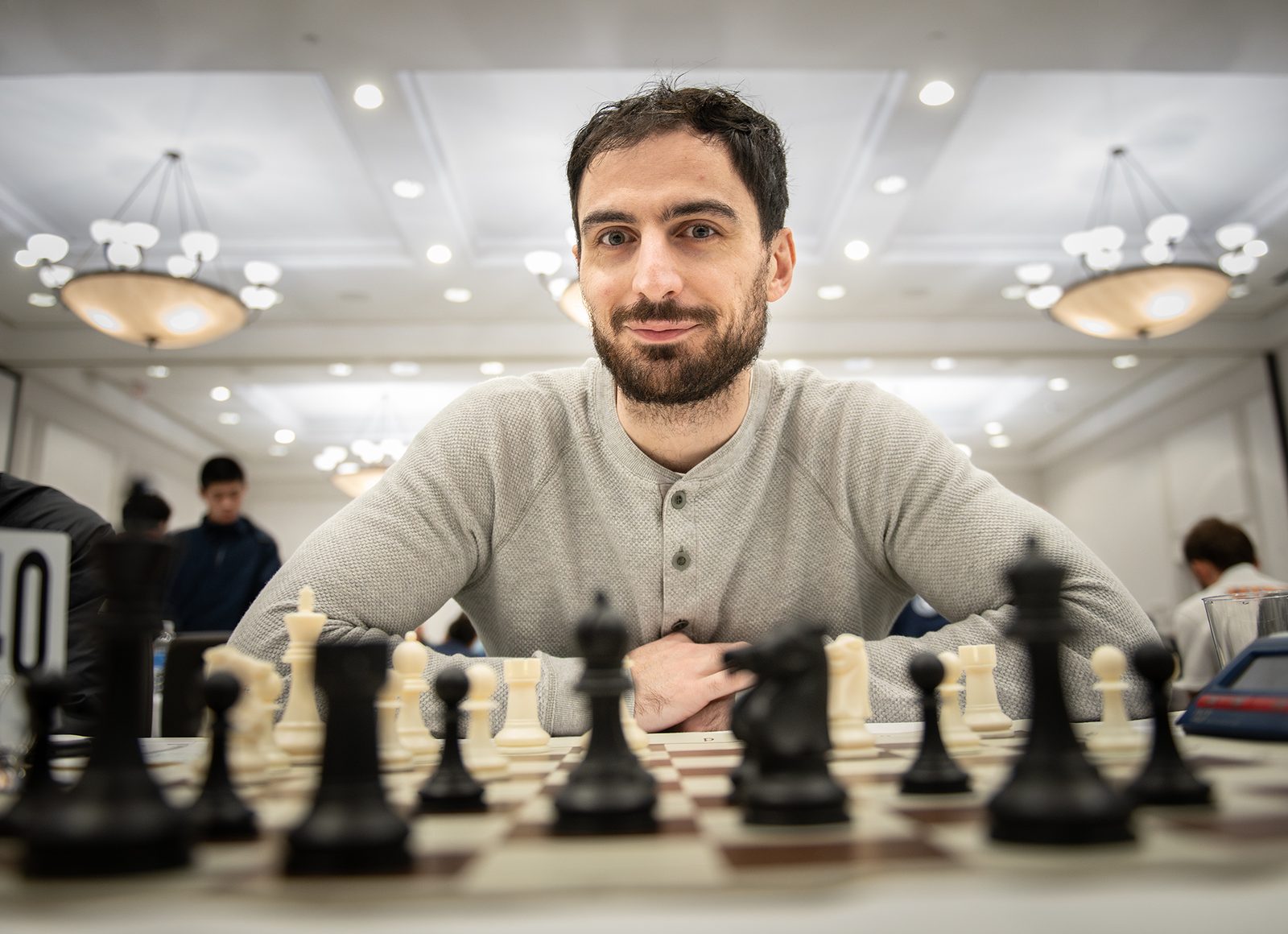 Zura Javakhadze seated at a chessboard during a tournament